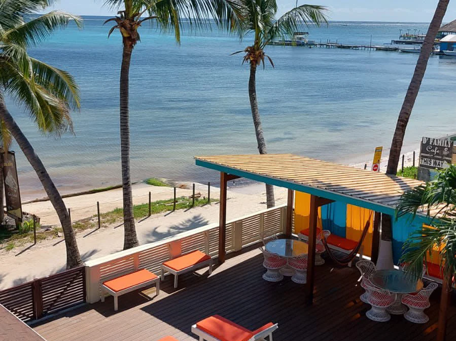 The view from a top-floor Reef View room at Ocean Tide Beach Resort, pool deck, beach, and the reef line beyond, San Pedro Belize